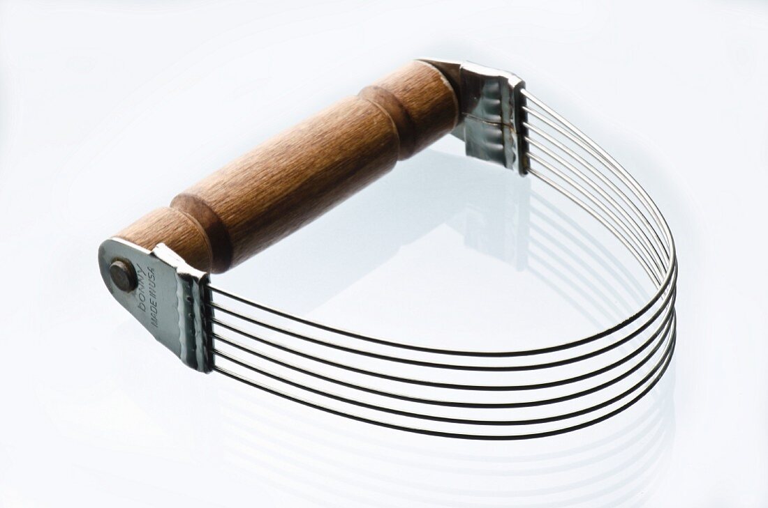 Metal Pastry Cutter with Wooden Handle on a White Background