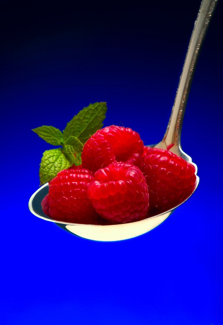 Spoonful of Fresh Strawberries on a Blue Background