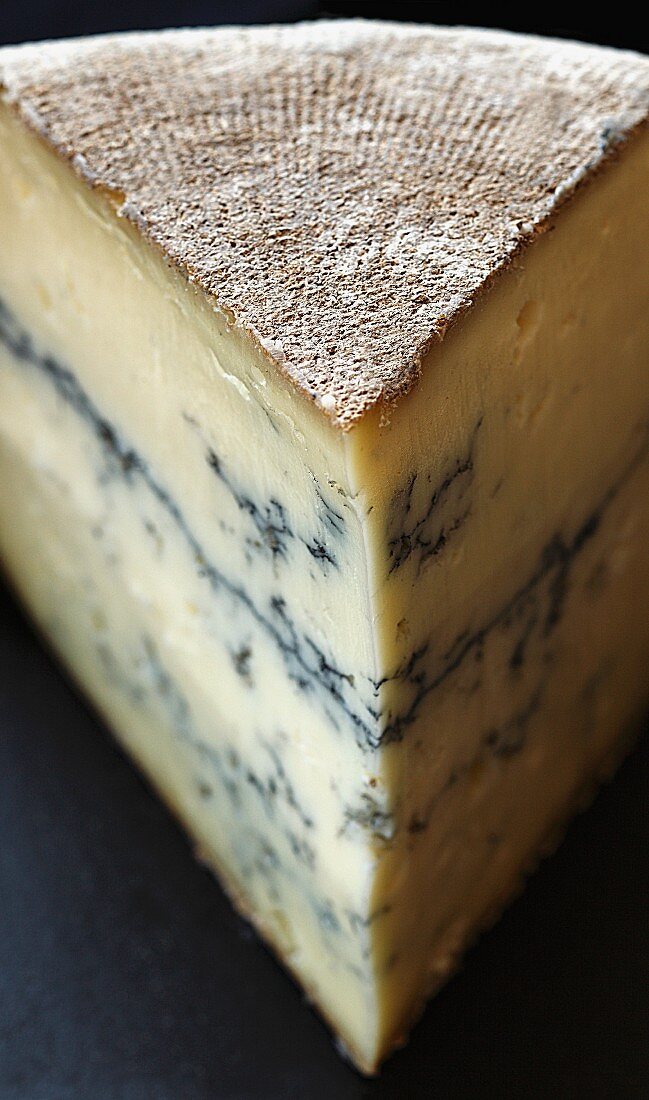 Wedge of Semi Firm Morbier Cheese with Ash Line
