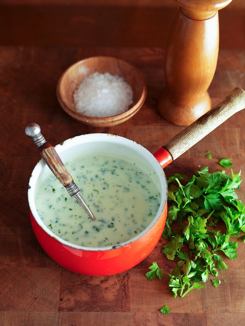 Parsley sauce in a saucepan