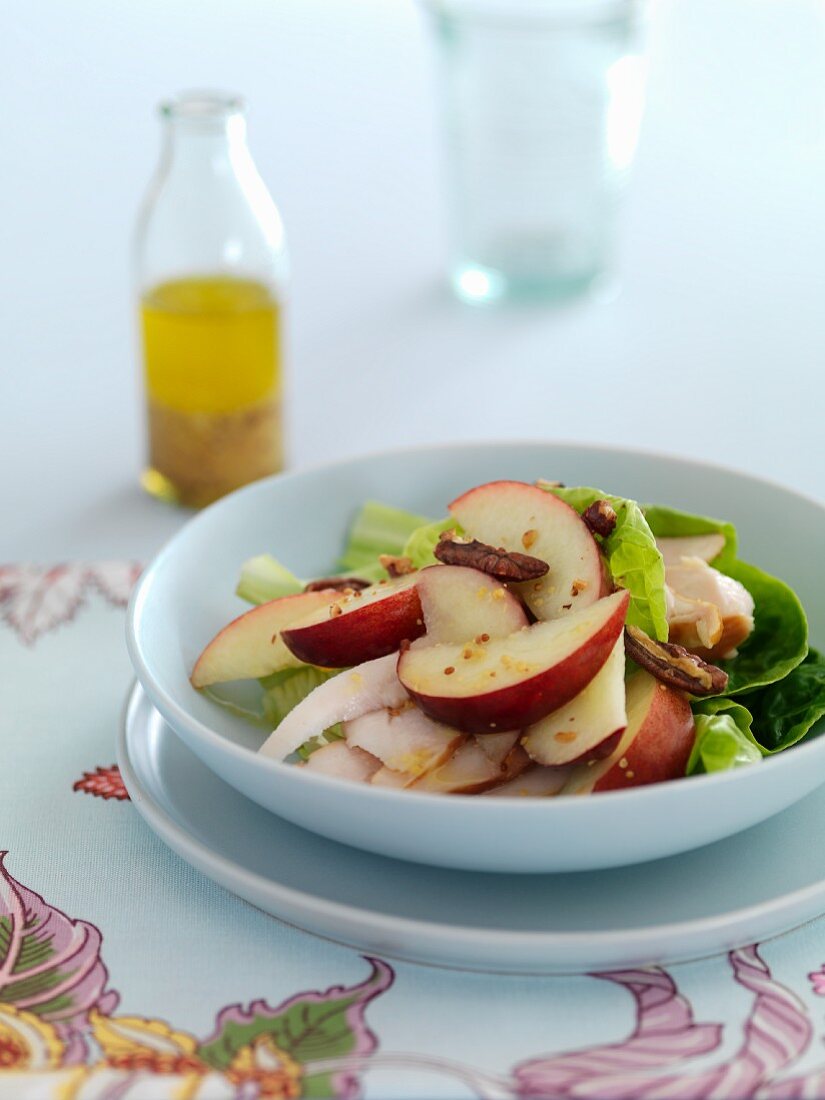 Peach and chicken salad with pecan nuts