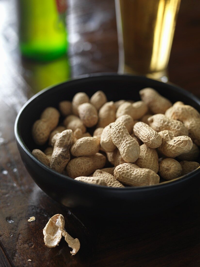 Peanuts in a bowl with a beer