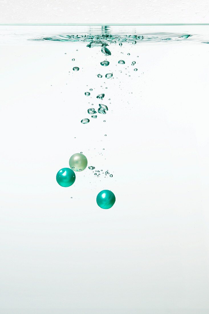 Turquoise balls and air bubbles in water
