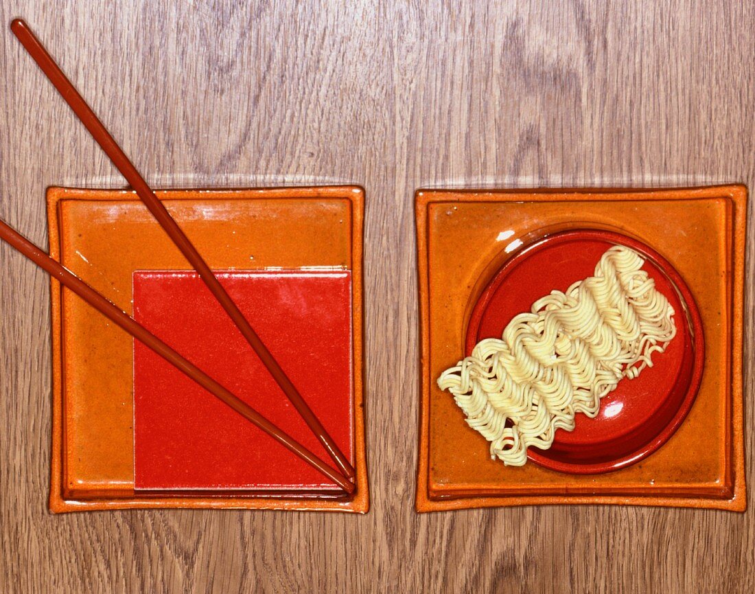 An oriental place setting with noodles