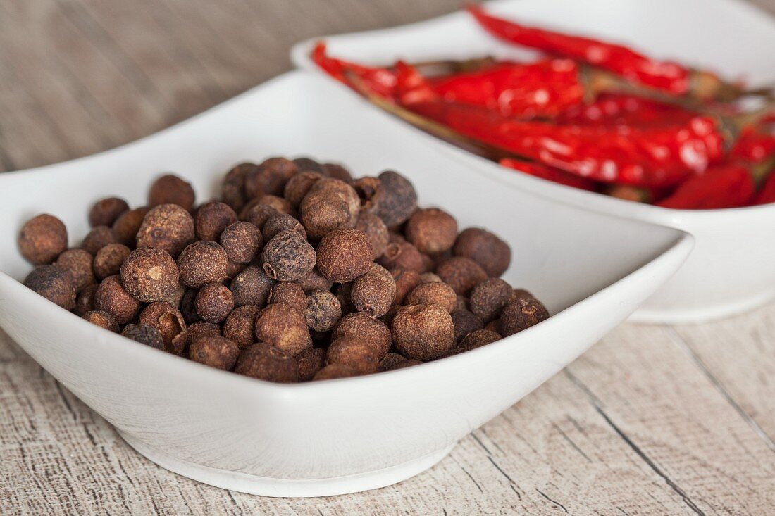Allspice berry and chilli peppers in a bowl