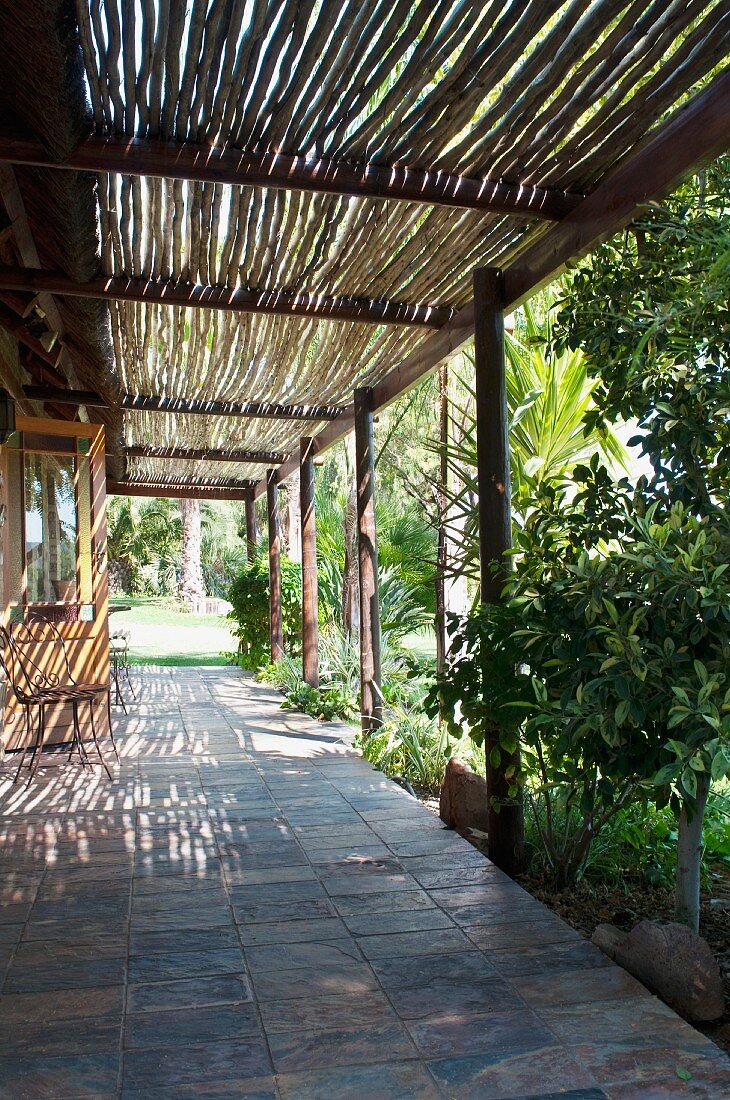 Terrace with pergola and view into tropical garden