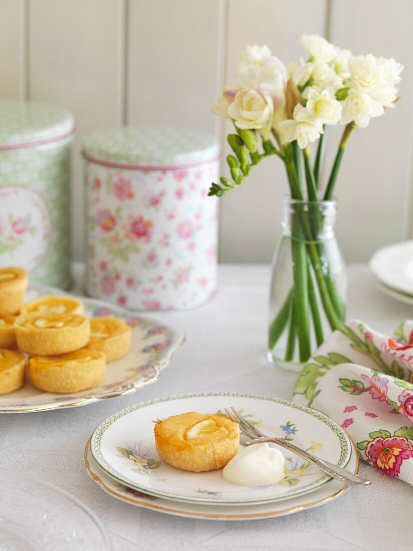 Lemon tartlets, a biscuit tin and a bunch of flowers