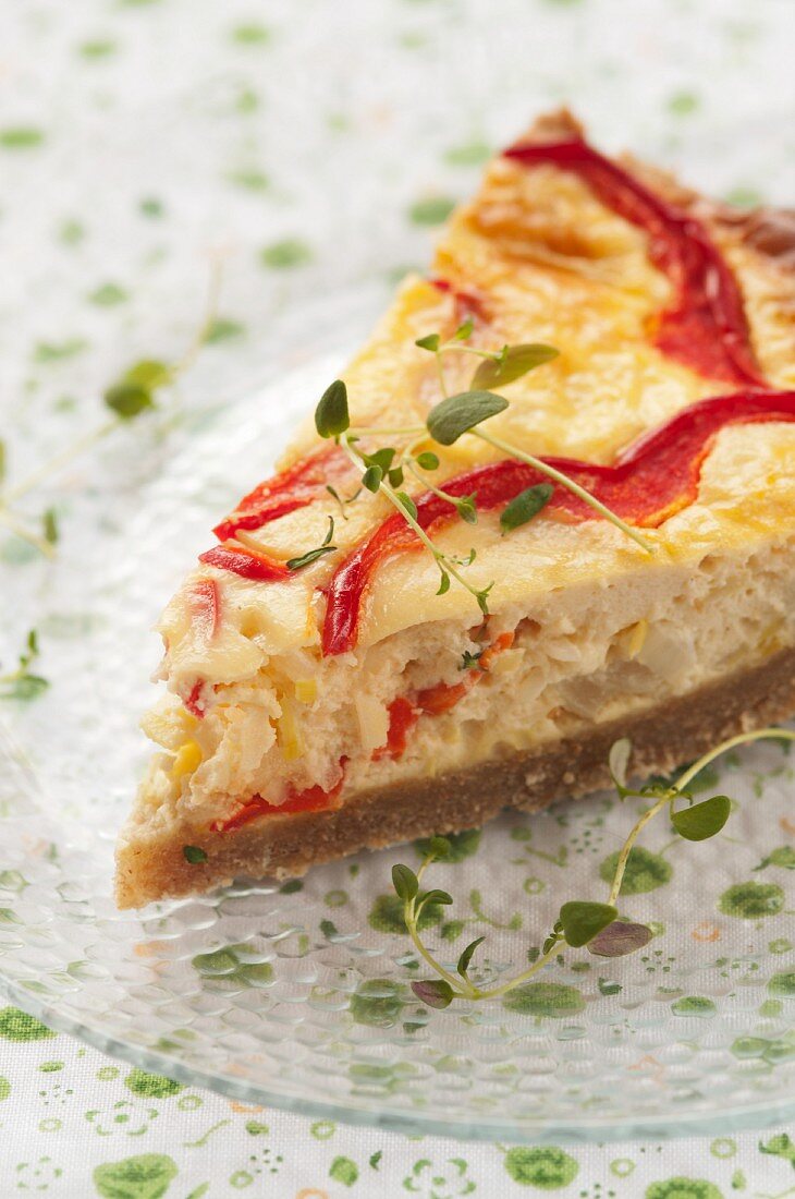A slice of vegetable tart with peppers and onions