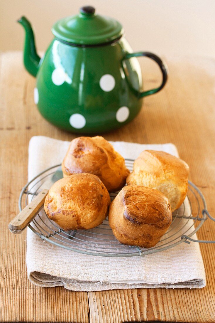 Scones on a wire rack with a teapot
