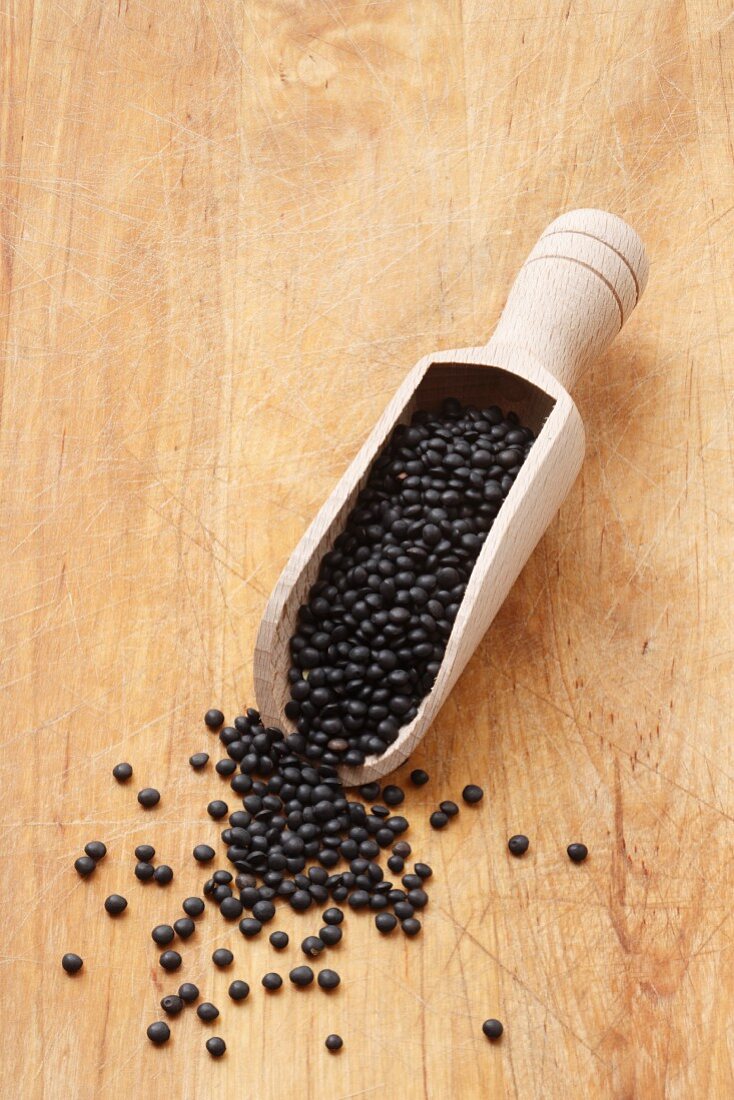 Beluga lentils in a wooden scoop