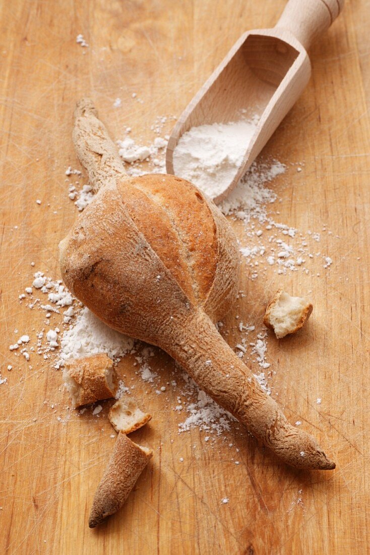 Bread and a wooden scoop with flour