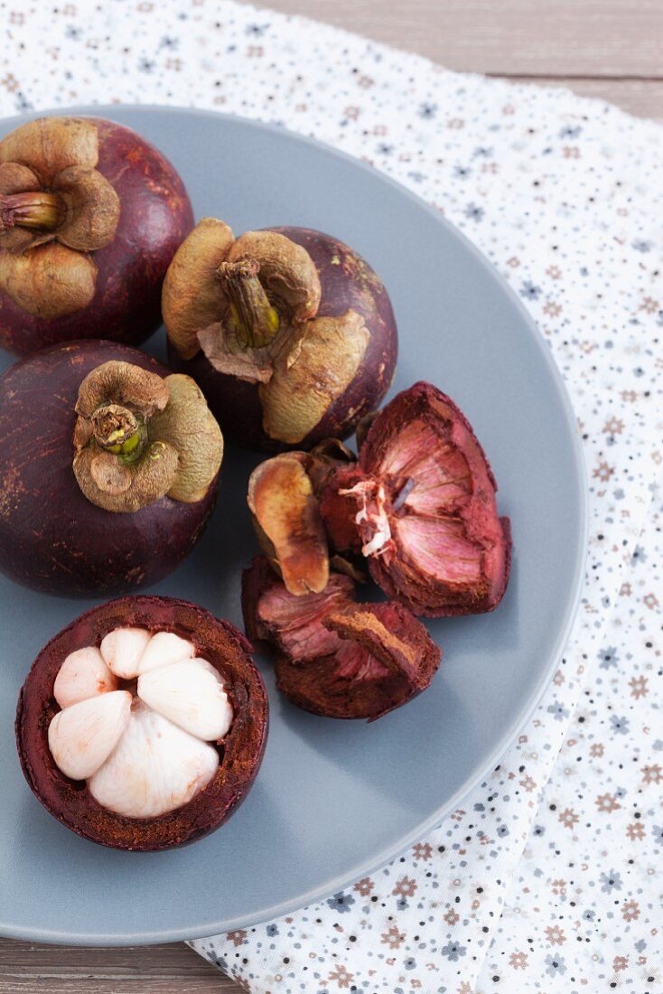 Mangosteens, whole and sliced