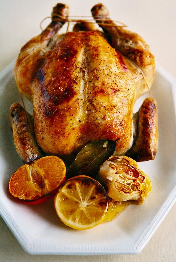 Roast chicken with citrus fruits and garlic