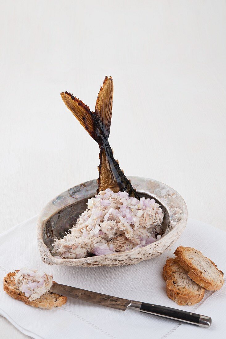 Mackerel pate in a shell garnished with a mackerel tail