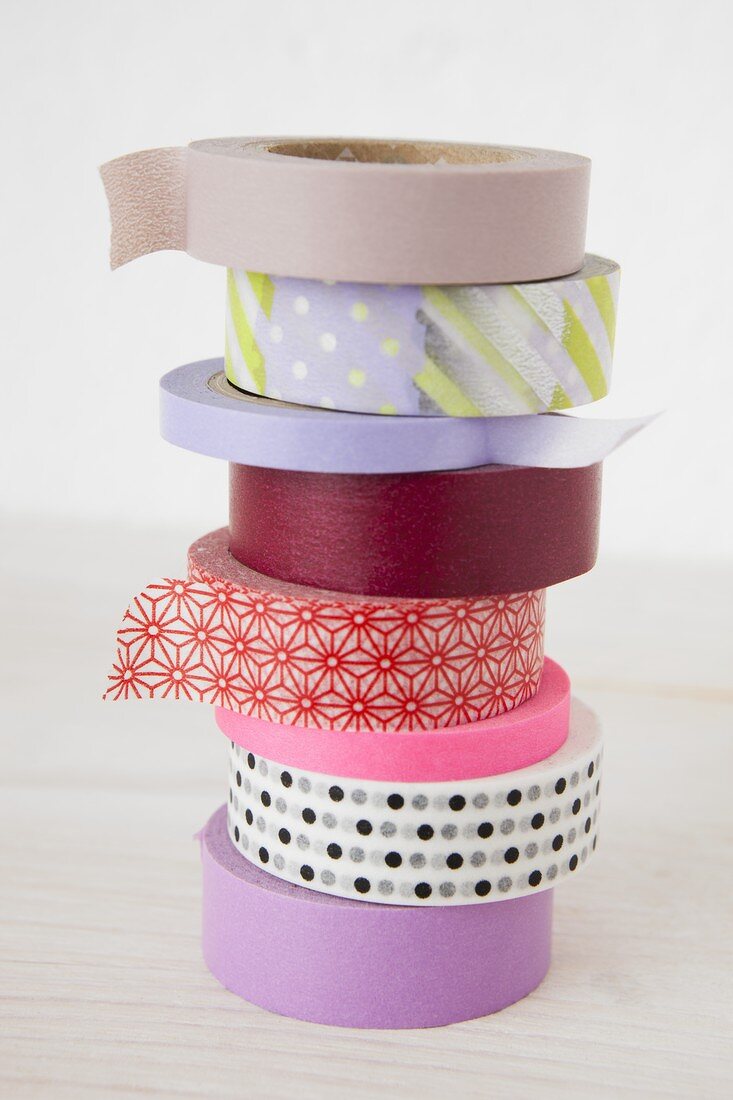 A stack of various rolls of masking tape