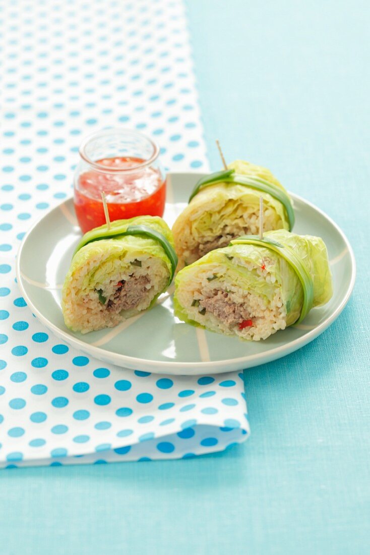 Savoy cabbage roulade filled with minced meat and rice with chilli sauce
