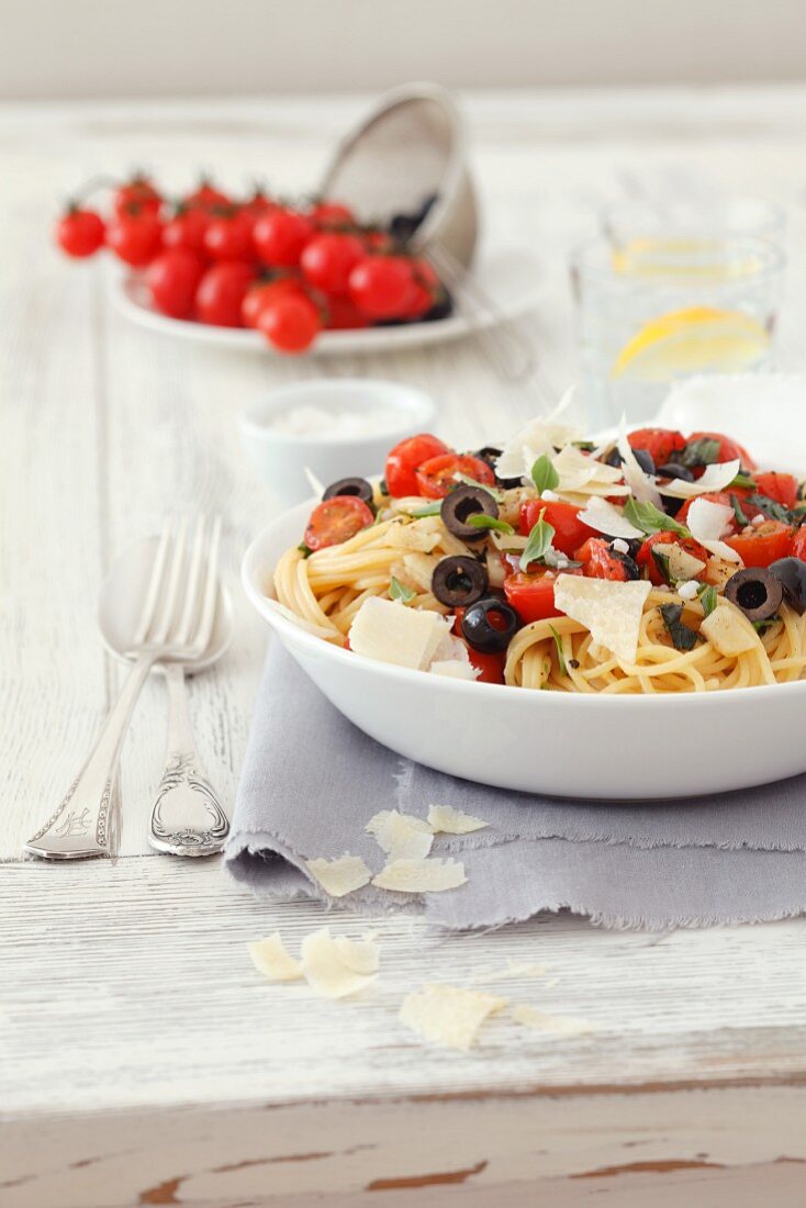 Spaghetti with cherry tomatoes, black olives, basil and Parmesan