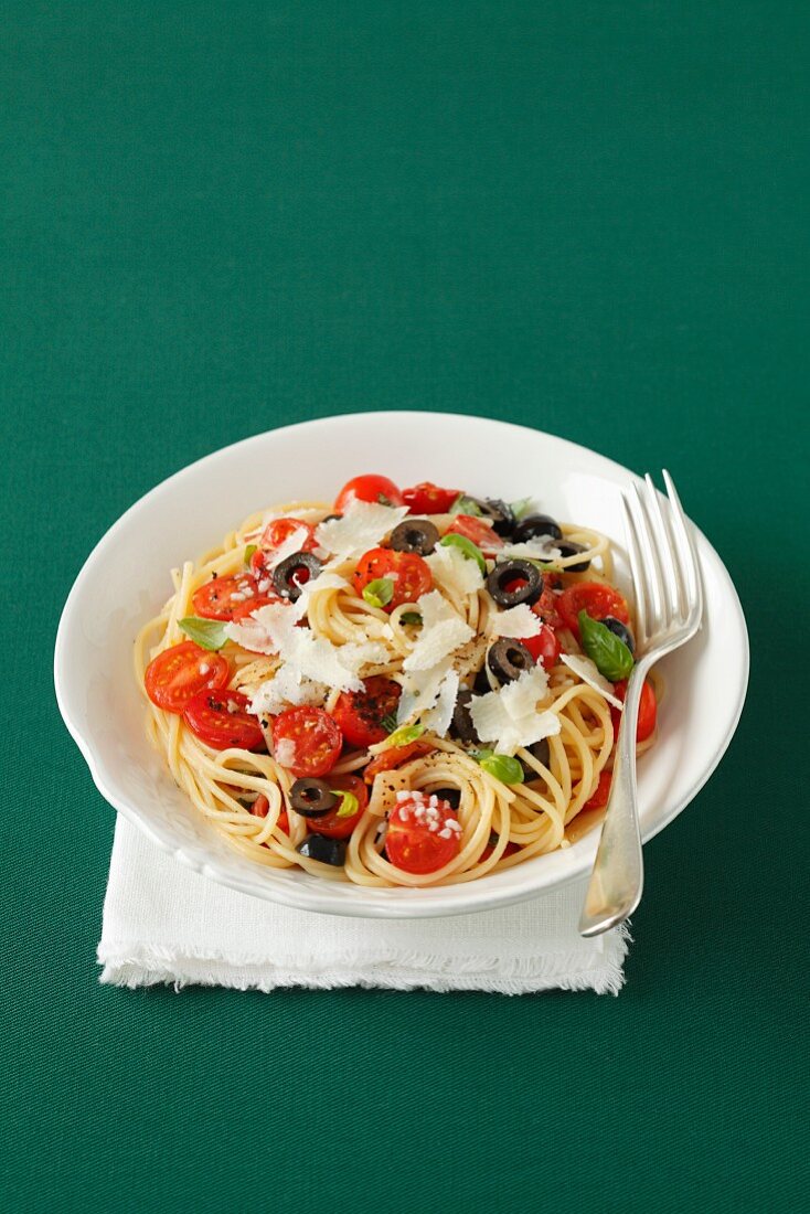 Spaghetti with cherry tomatoes, black olives, basil and Parmesan