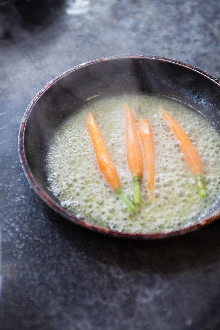 Carrots being fried in butter