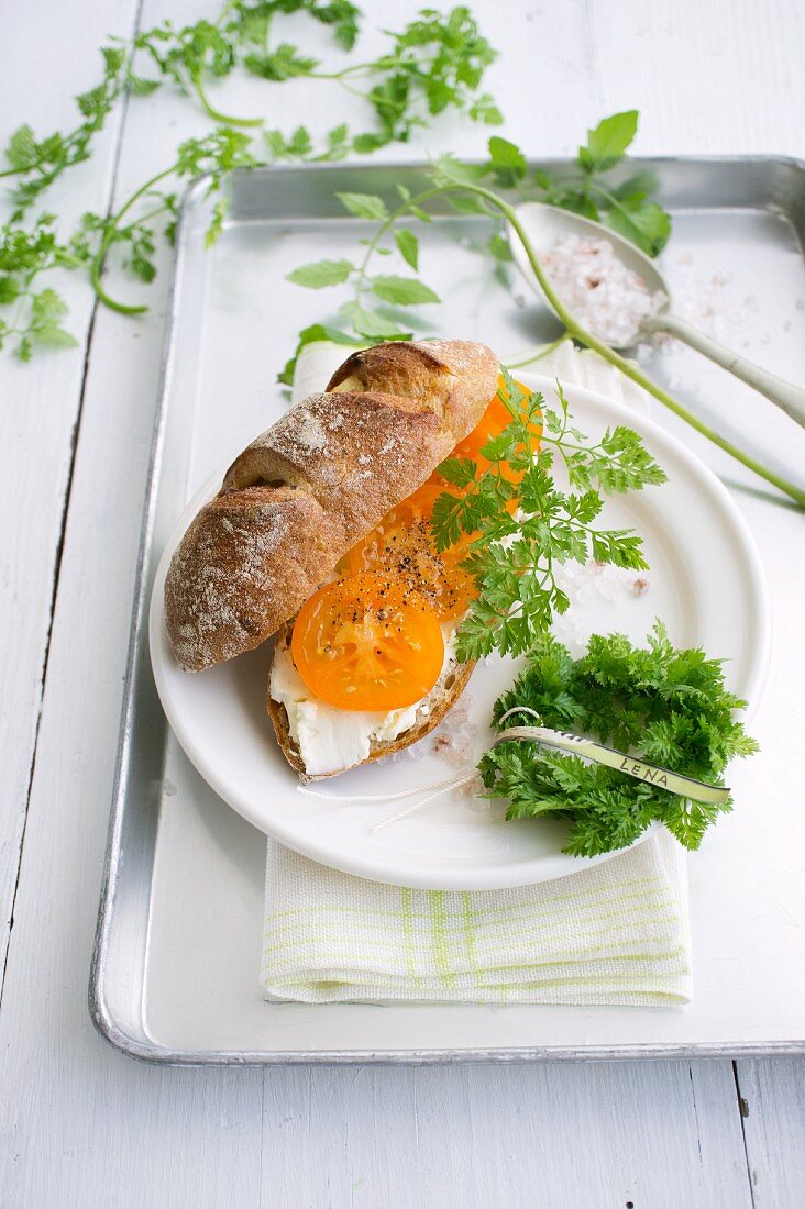 Homemade potato bread with tomatoes, cream cheese and chervil