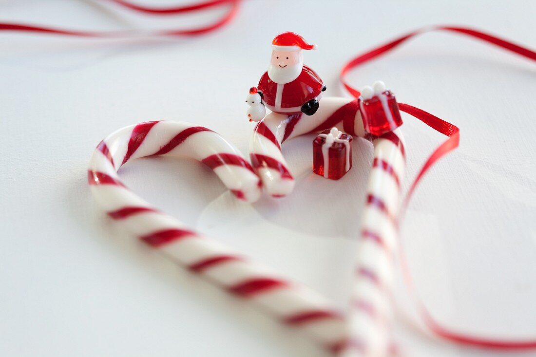 A candy cane heart, a Father Christmas figure and glass ornaments