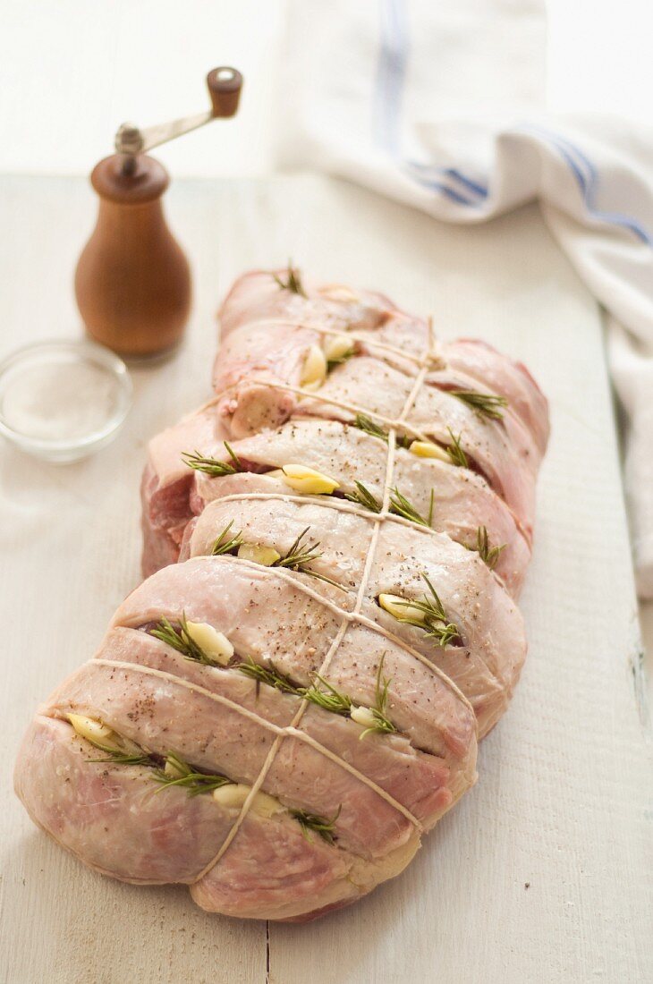 Leg of Lamb with Slits Stuffed with Garlic and Rosemary; Tied and Ready for Roasting