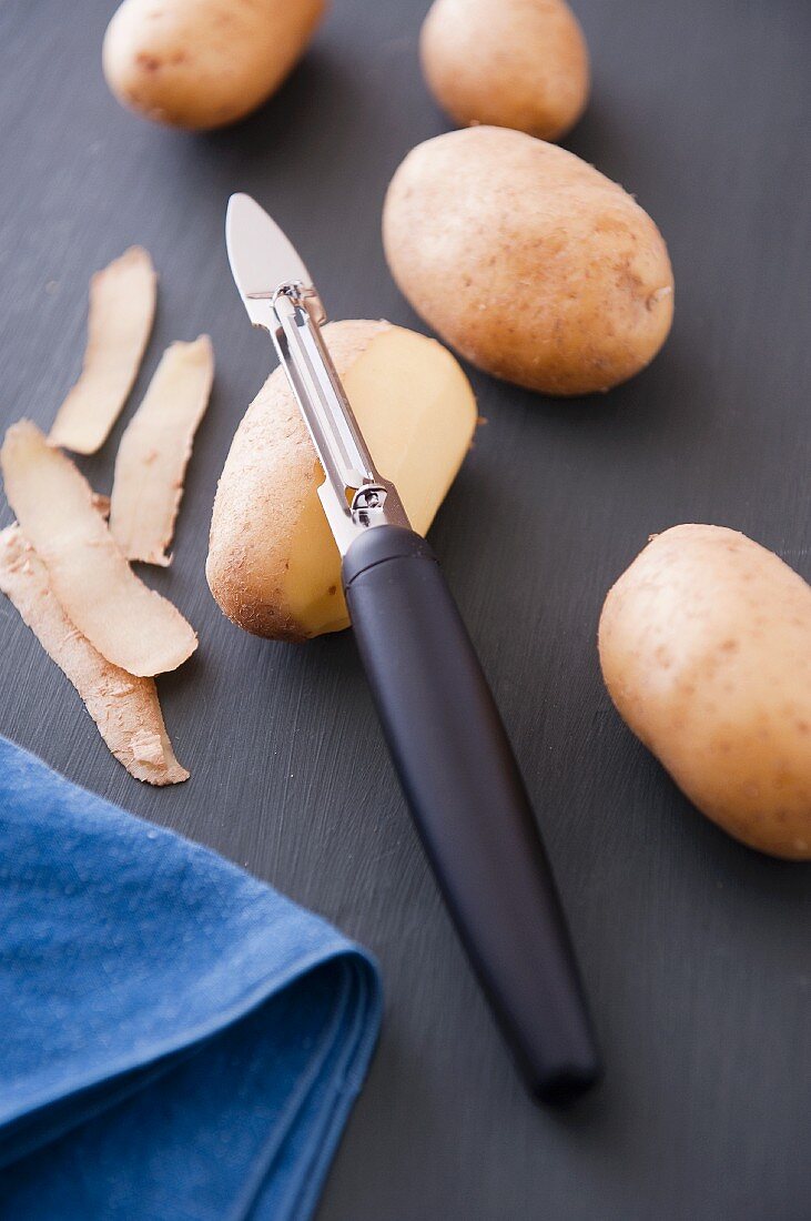 Potatoes and a potato peeler