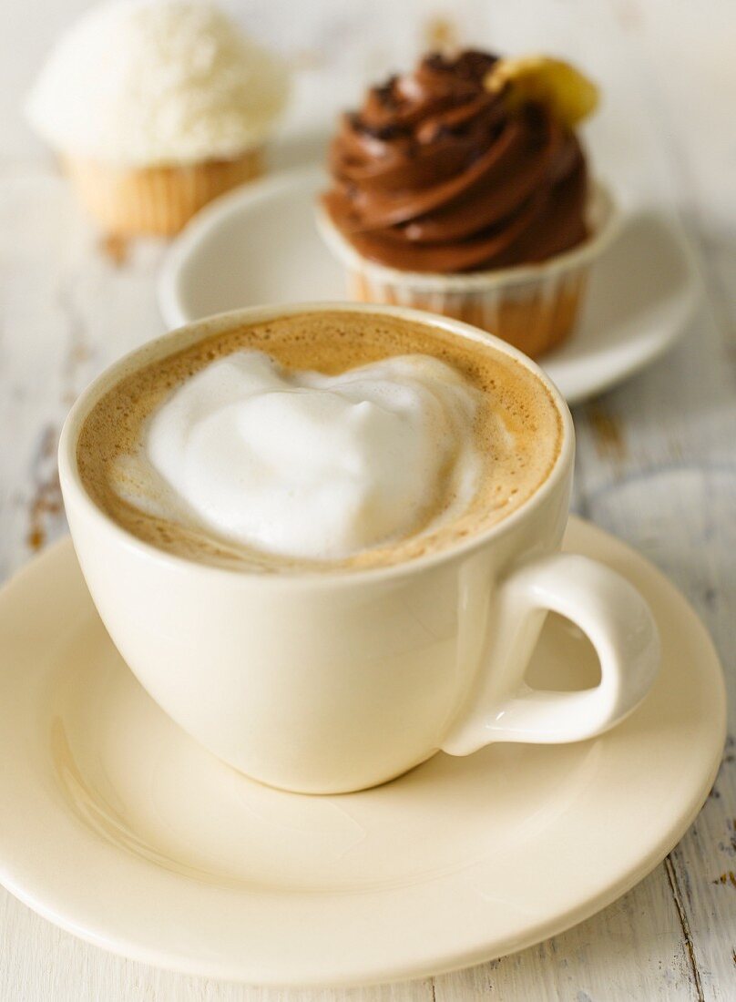 A cappuccino with cupcakes