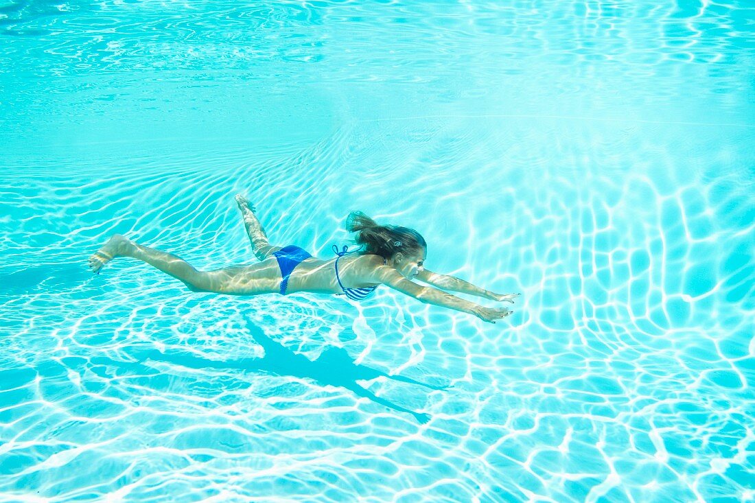 Woman in bikini swimming in pool