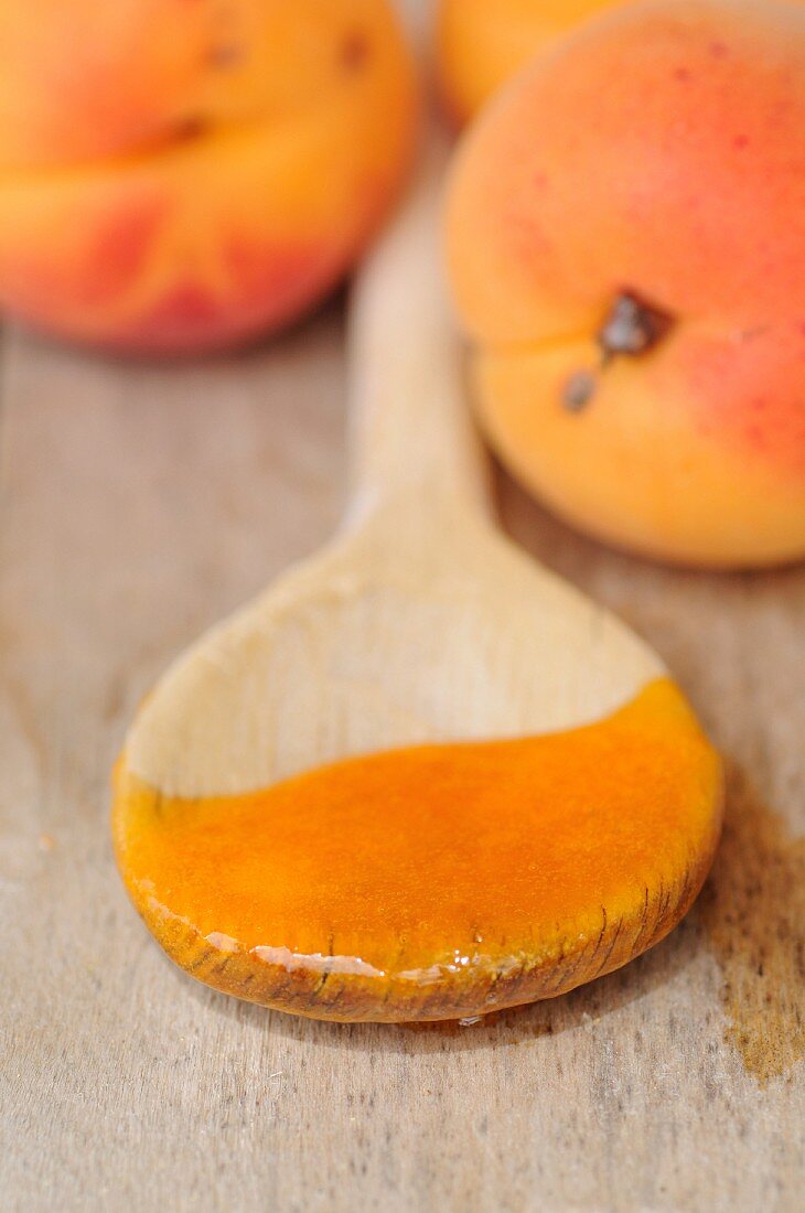 Apricot jam on a wooden spoon