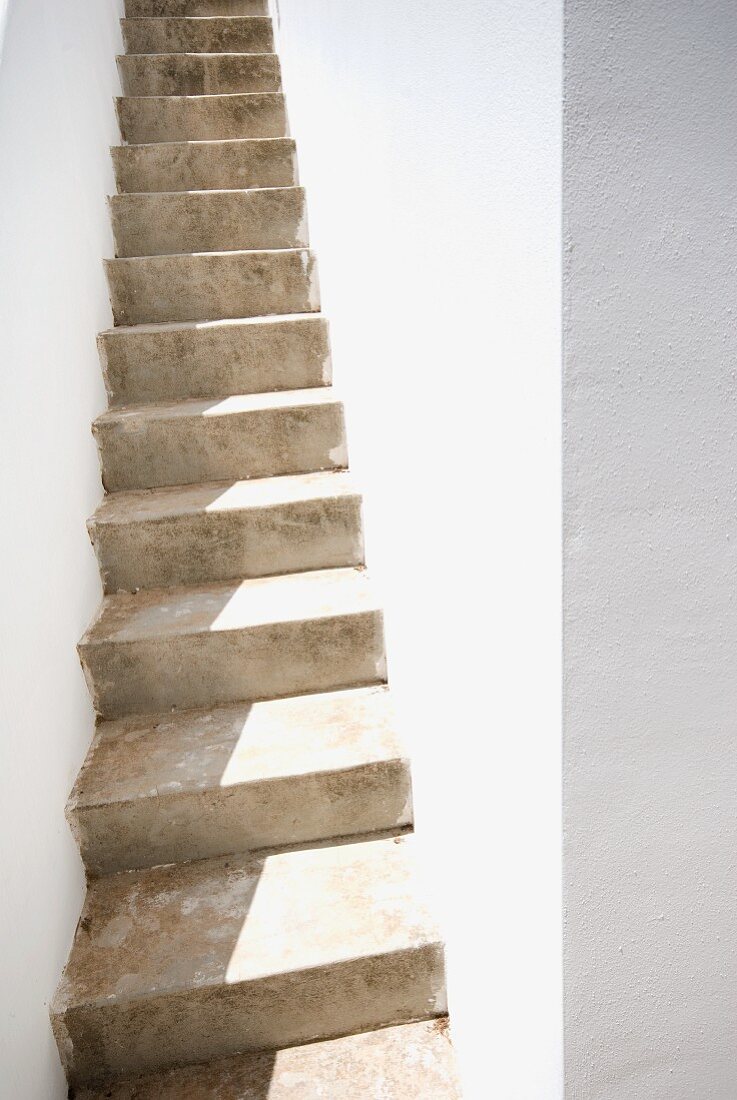 Narrow, stone stairway between walls of house