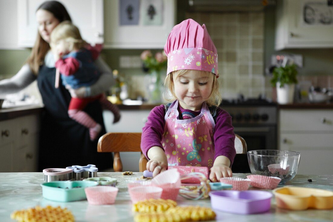 A mother and daughter baking in a kitchen
