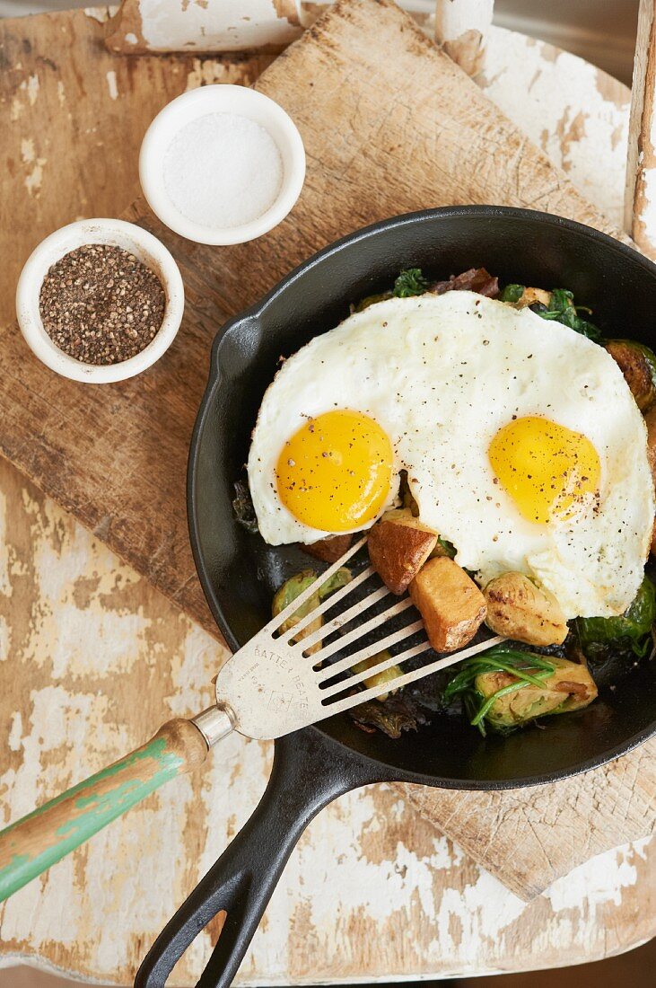 Vegetable Hash Topped with Two Sunny Side Up Eggs in a Skillet