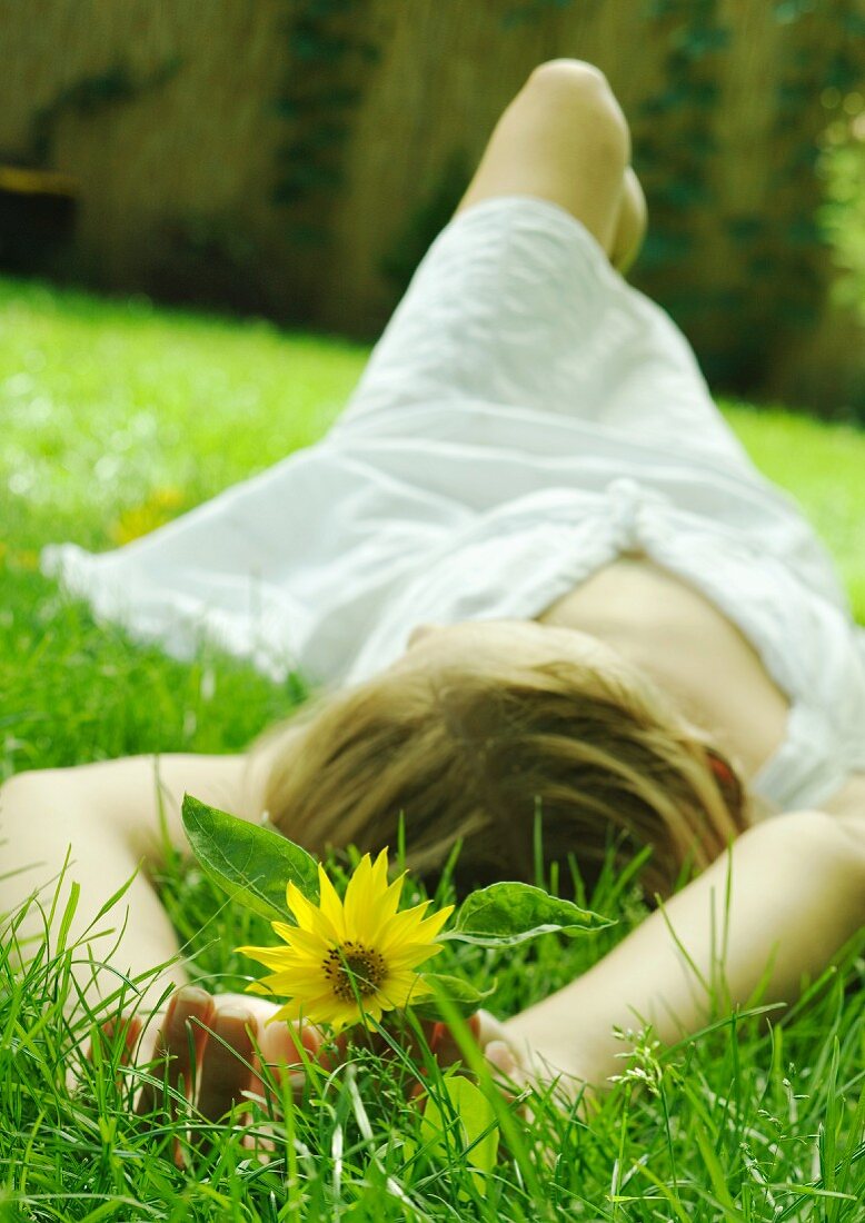 Young woman lying on grass