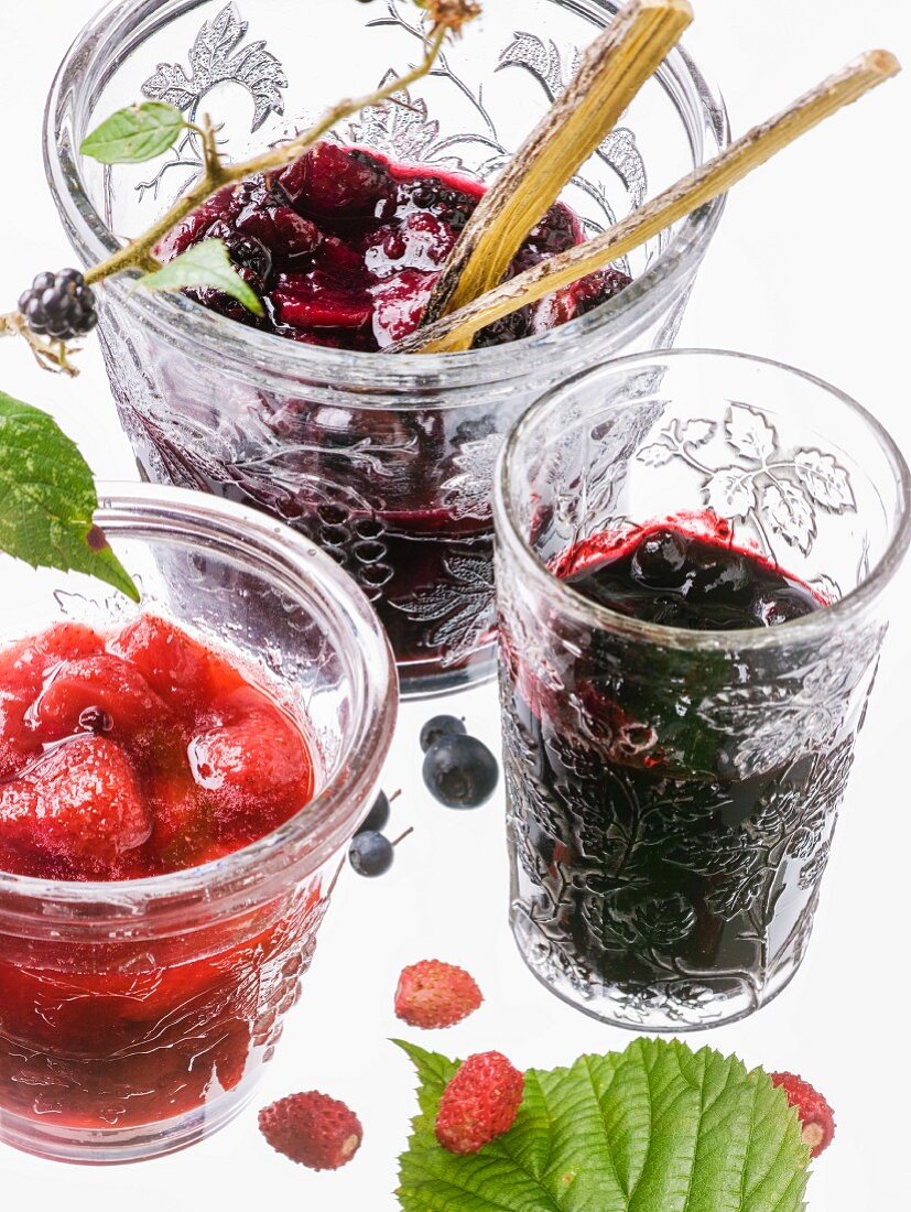 Three types of berry jam in glasses