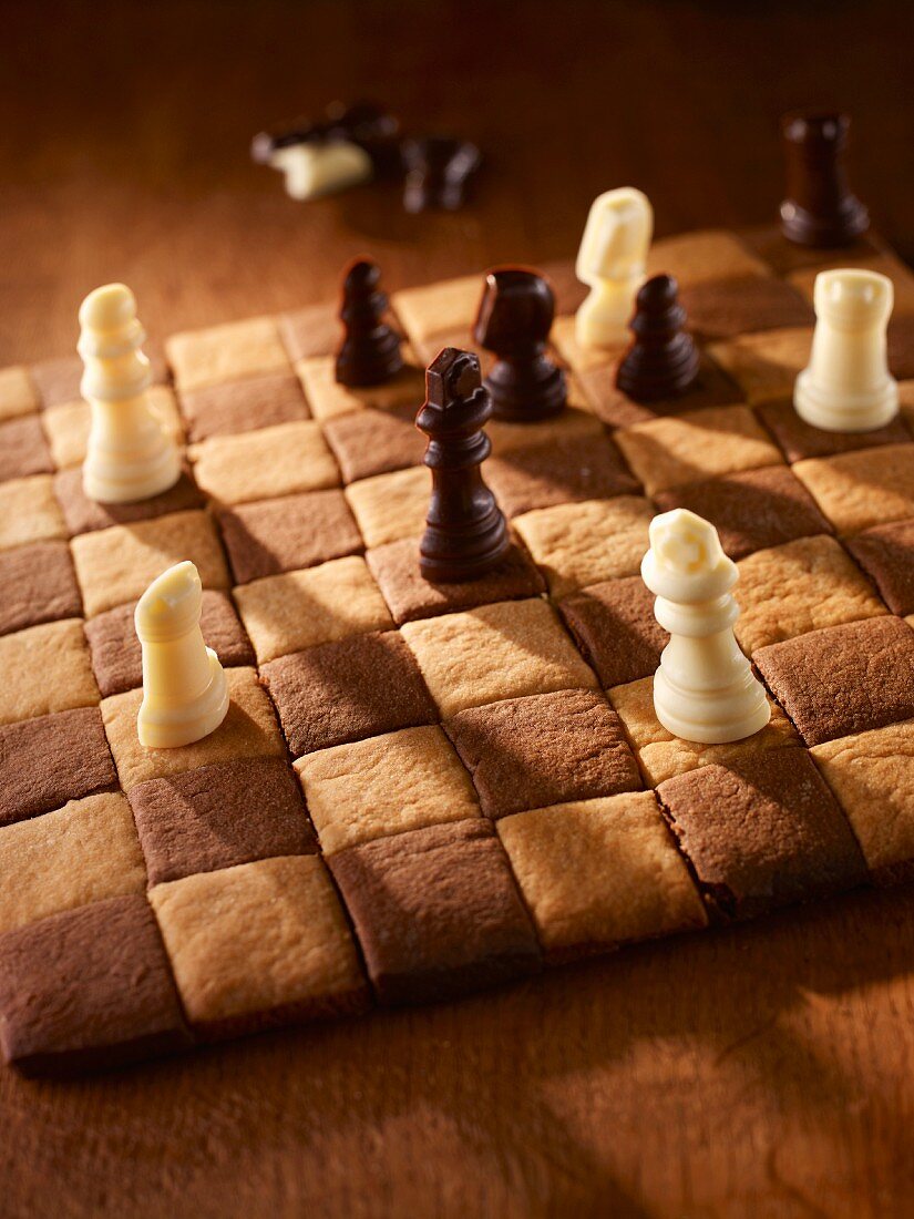 A chessboard cake with chocolate figures