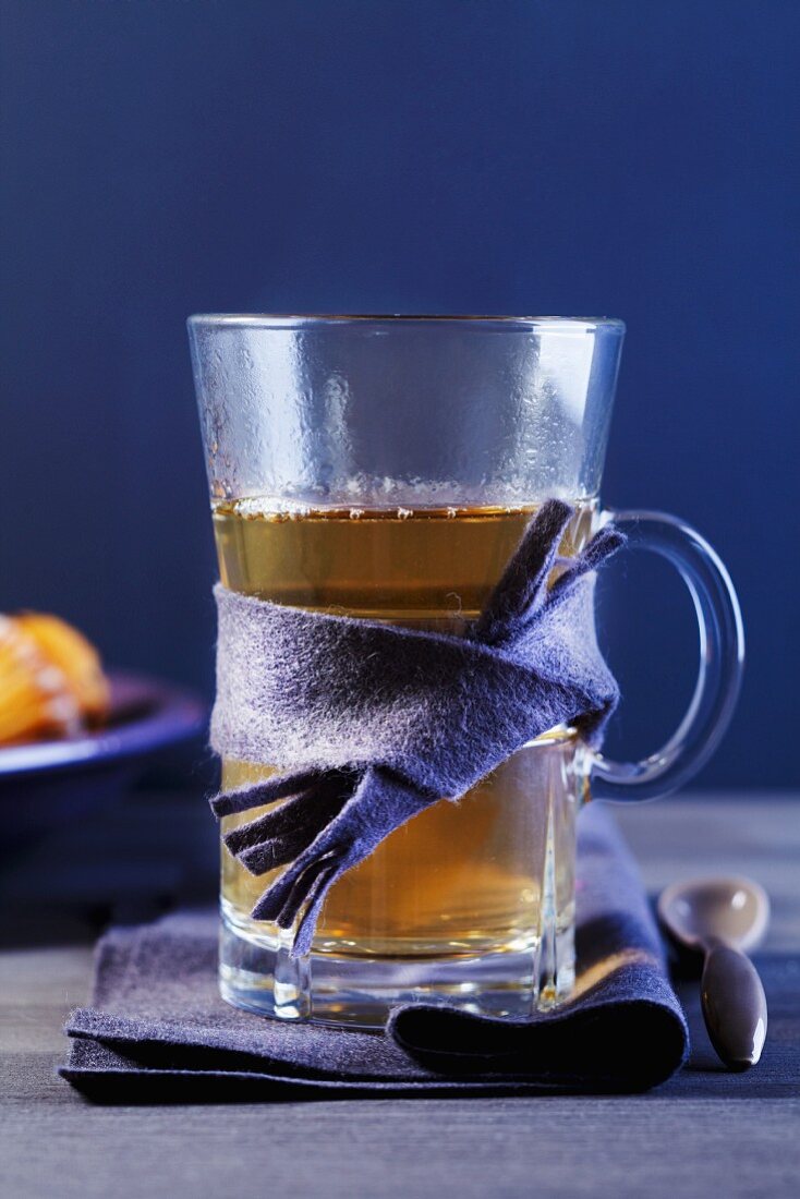 A glass of tea wrapped in a piece of felt