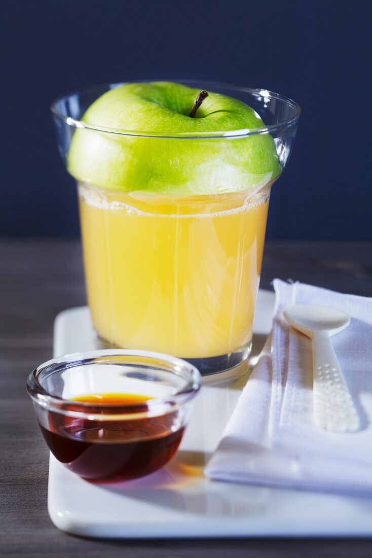 Apple punch in a glass with a slice of apple as a lid