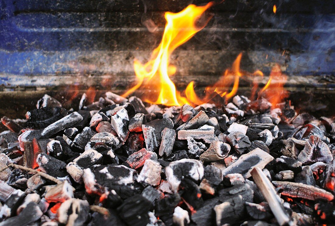 Burning charcoal on barbecue grill