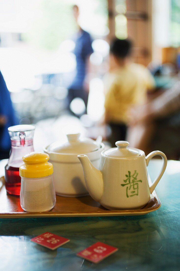 Teeservice und Gewürze auf Tablett im Chinarestaurant