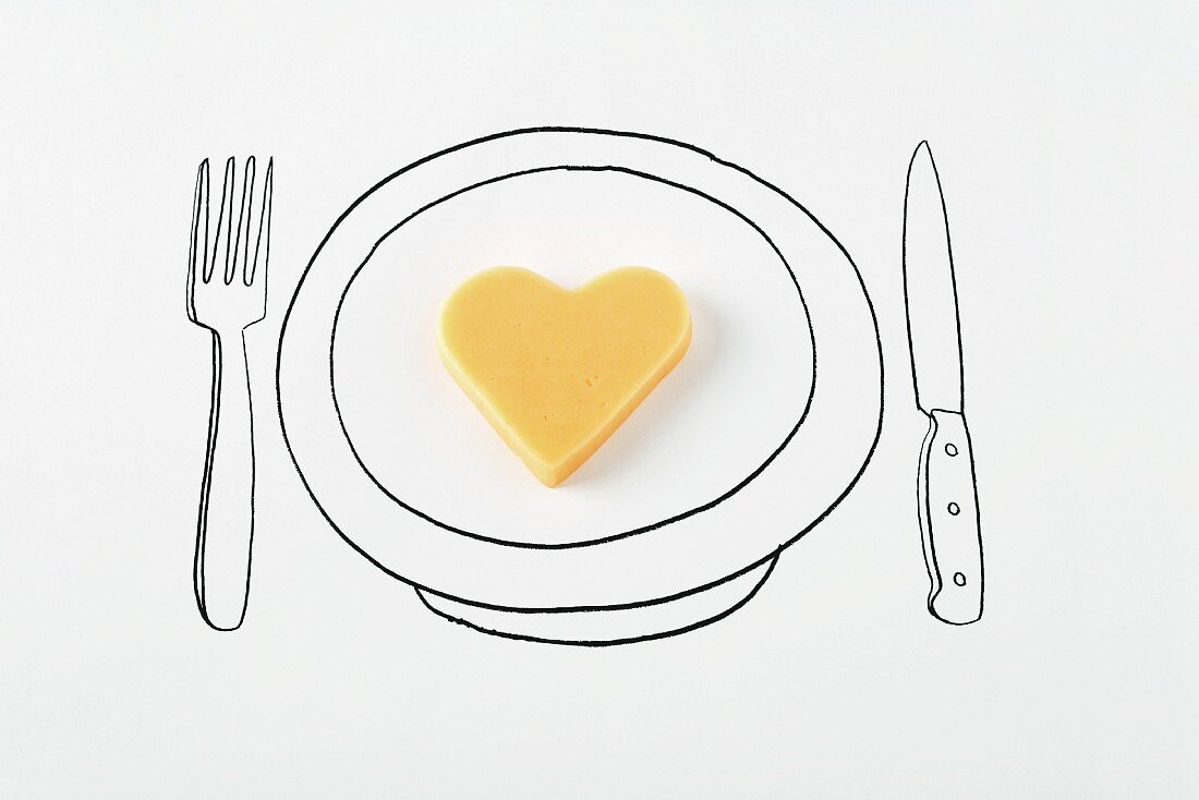 Heart-shaped cheese on drawing of plate
