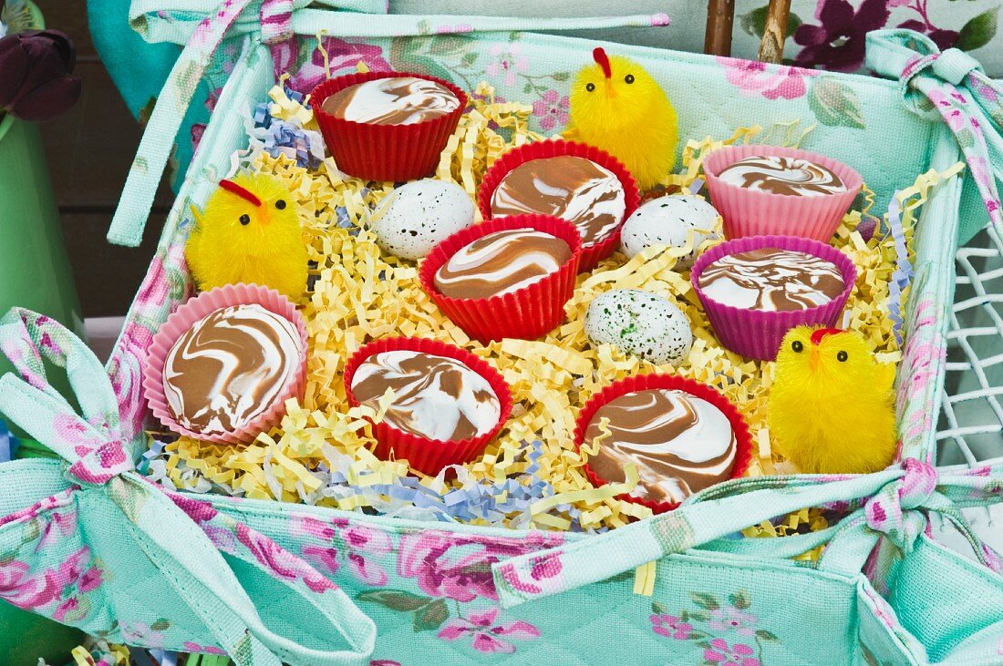 Desserts in colourful cases and Easter decorations in fabric-covered box
