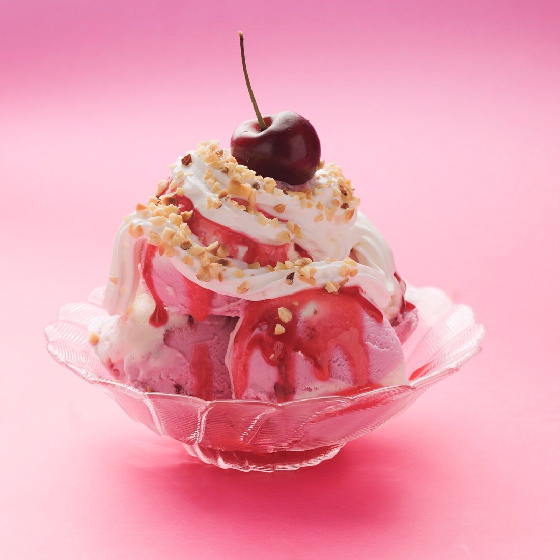 Raspberry and vanilla ice cream with cream and raspberry sauce