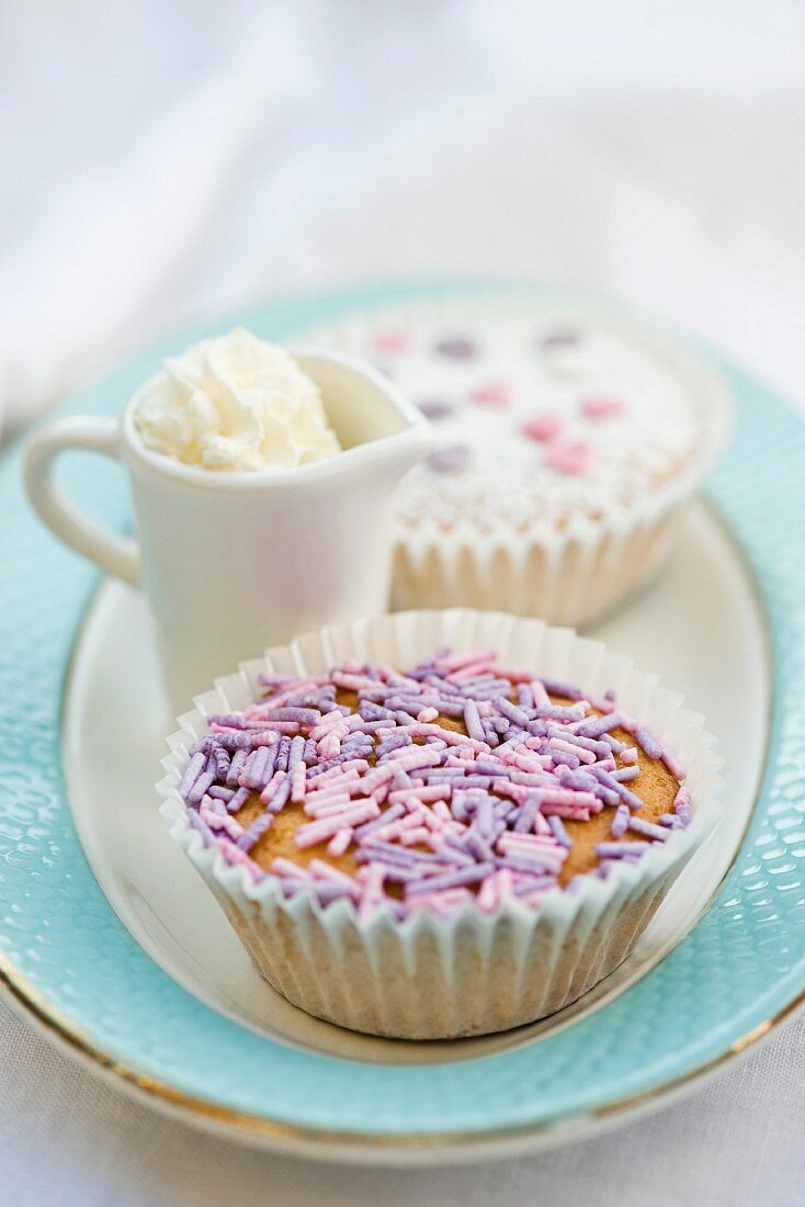 Bizcocho (sweet cakes from Spain) with sprinkles and cream