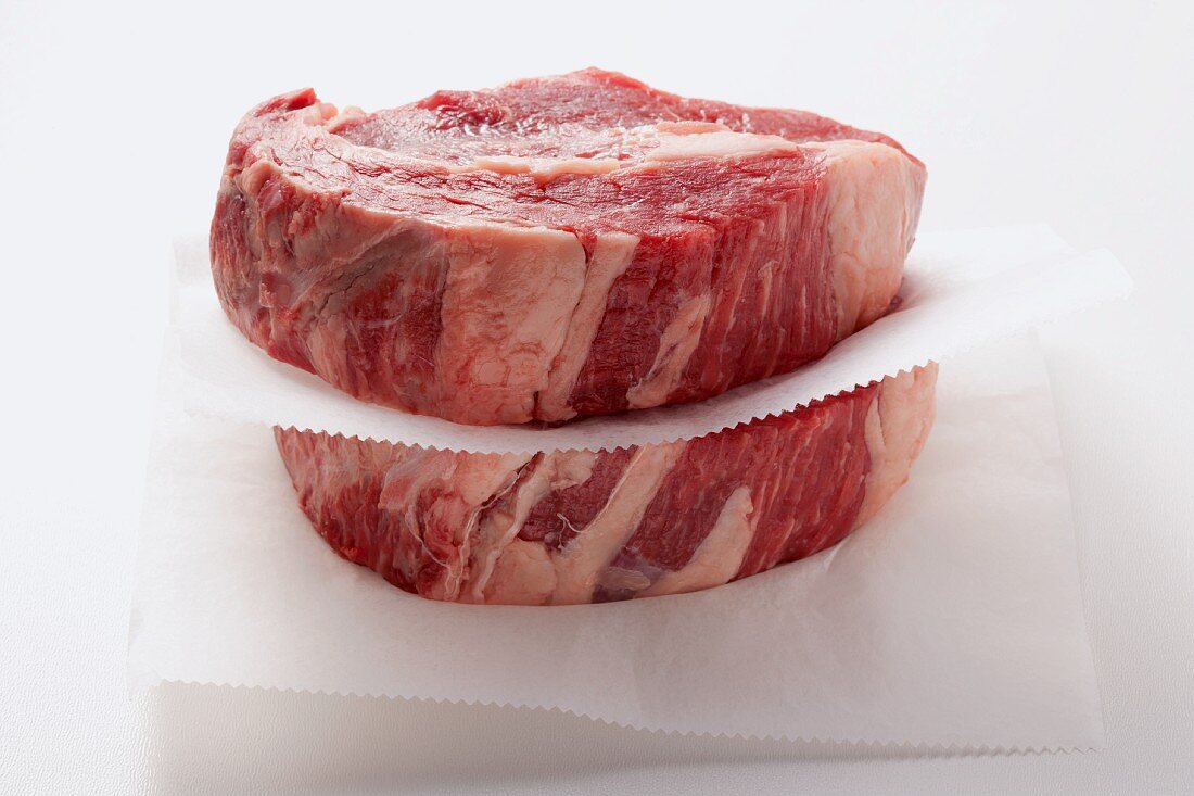 Beef steaks on paper