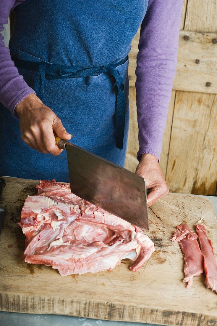 A duck being cut with a cleaver