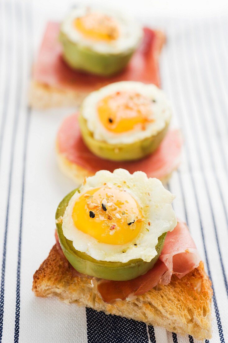 Toast topped with ham, artichokes and fried eggs