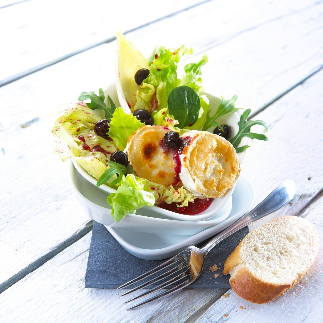 Goat's cheese on a salad with blueberry dressing