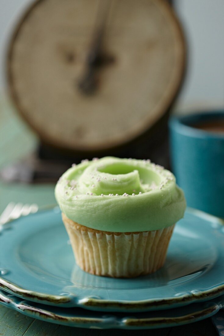 Frosted Mint Cupcake on Two Stacked Blue Plates