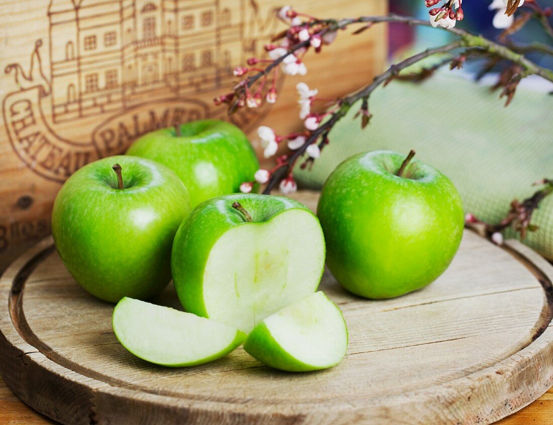 For Granny Smith apples on around chopping board